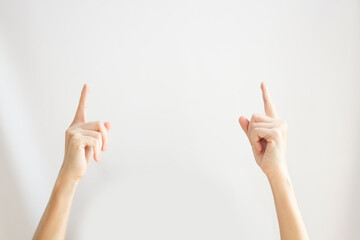 Two Woman's hand are pointing or indicating to copy space area for communication and advertisement and promotion and text on a white background