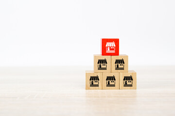 Franchise or franchising, Cube wooden block stack in pyramid with franchises business store icon for growth and products services or branch expansion bank loan.