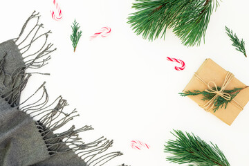 Christmas holiday decorations with scarf, pine branch, candy and gift box on white background. Winter concept. Flat lay