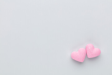 Fototapeta premium Composition with candy hearts on pastel blue background.