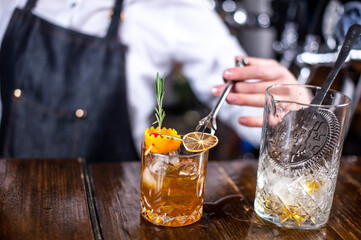 Girl barman makes a cocktail in the pothouse