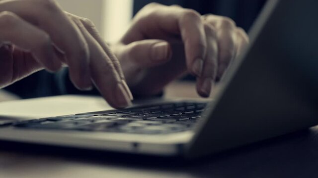 Close up of hands typing on laptop