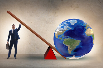 Businessman lifting the earth in challenge concept