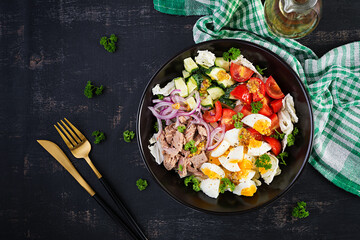 Healthy food. Tuna fish salad with eggs, lettuce, cherry tomatoes, cucumber and red onions.  French cuisine. Top view,  flat lay