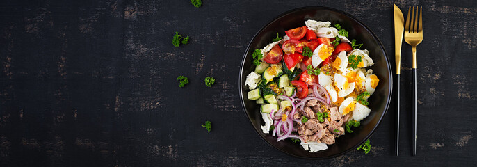 Healthy food. Tuna fish salad with eggs, lettuce, cherry tomatoes, cucumber and red onions.  French cuisine. Top view, banner