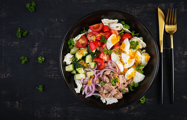 Healthy food. Tuna fish salad with eggs, lettuce, cherry tomatoes, cucumber and red onions.  French cuisine. Top view,  flat lay