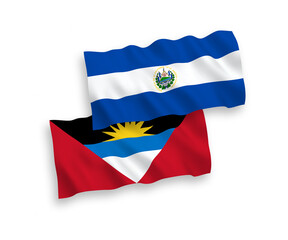 National vector fabric wave flags of Republic of El Salvador and Antigua and Barbuda isolated on white background. 1 to 2 proportion.