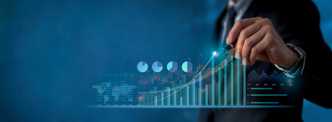 Close up of Businessman draws growth graph and progress of business and analyzing financial and investment data, business planning and strategy on blue background.