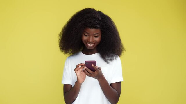 Cheerful blogger lady hold telephone make smm post on lemon backdrop