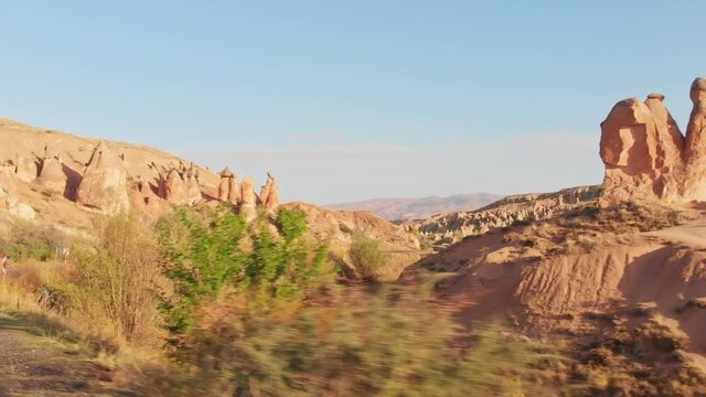 Window point of view driving in cappadocia outdoors on sunrise with devrent valley fairy chimneys background .Travel and tourism in Turkey concept