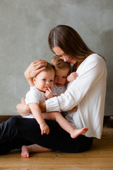 Mother with one year old twins in her hands.