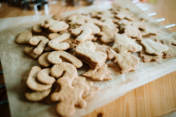 Gingerbread christmas cookies cutters and rolling pin over wooden pastry board