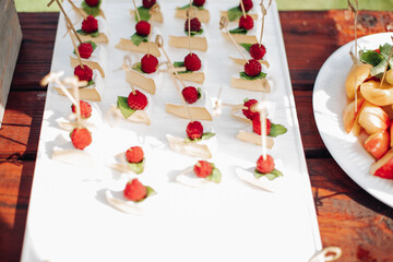 a lot of small cheescakes with raspberries on them