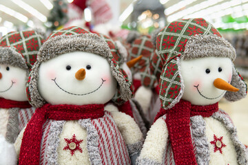 Smiling snowman's dolls in the store on on the eve of Christmas and New Year