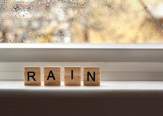 the word rain writen with wooden letters
