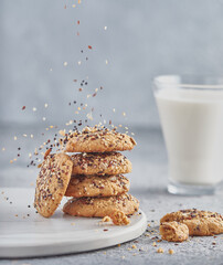 Glass of milk and oatmeal cookies on a light background. Evening snack or breakfast