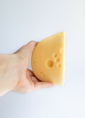Hand Holding Piece of Cheese on a white background isolation Studio Shot. Side View. Dairy Food and Cooking at Home Concept for Flyers and Banners
