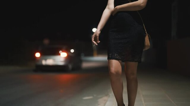 Female prostitute with cigarette on the street.