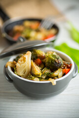fried brussels sprouts with cauliflower and other vegetables in a bowl
