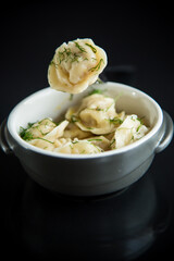 boiled dumplings with meat filling in a bowl
