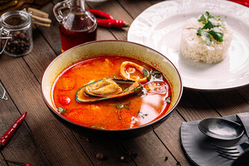 Top view on gourmet thai seafood soup tom yam with rice