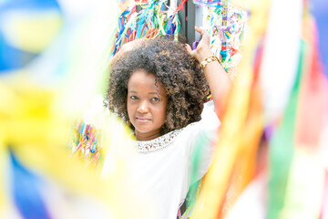 Portrait of a model smiling against colorful background.