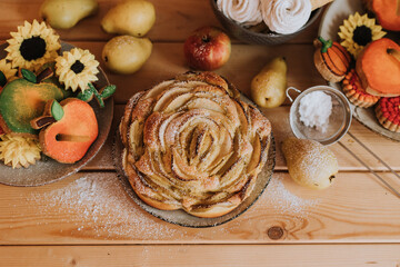 homemade cakes, sweets and fruits are on the wooden kitchen table. waffles, marshmallows, marmalade, cookies, gingerbread, apple pie. High quality photo