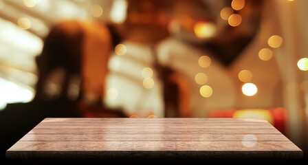 Fototapeta na wymiar Empty wooden table top with lights bokeh on blur restaurant background 
