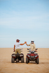 Atv racers in helmets, freedom riding in desert © Nomad_Soul