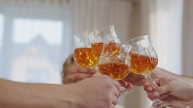 Happy family time and relationship. Close up view of the big family having party eating food and toasting wine glass together at home. People is happy and enjoy eating meal on dining table at home