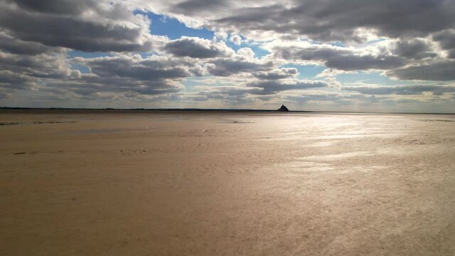 Fast flying over the sand surface of the Mont Saint Michel bay, Normandy, France