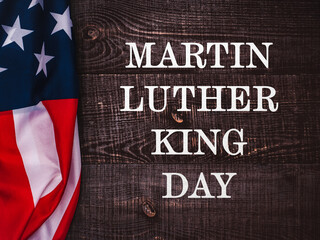 Fototapeta na wymiar Happy Martin Luther King day. Congratulatory inscription on the background of the American Flag. No people. Closeup, top view. Congratulations for family, relatives, friends and colleagues