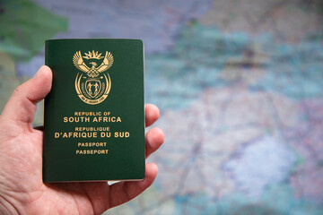 Selective focus on a South African Passport in a caucasian hand.  Concept for travel restrictions...