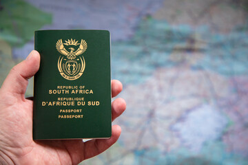 Selective focus on a South African Passport in a caucasian hand.  Concept for travel restrictions due to the omicron covid variant 