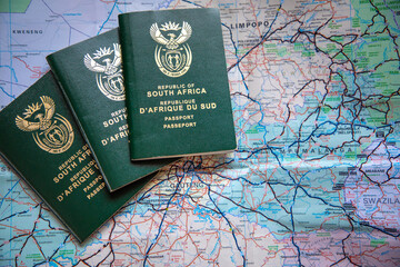 Three South African passports agains a map of South Africa. Concept for covid travel restrictions 