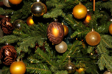 Obraz na płótnie Canvas Christmas tree decorated with golden baubles ready for the festive season.