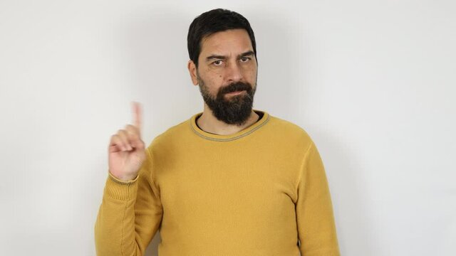 Man warning with admonishing finger gesture, saying no, be careful, disapproval sign. Isolated on white background.