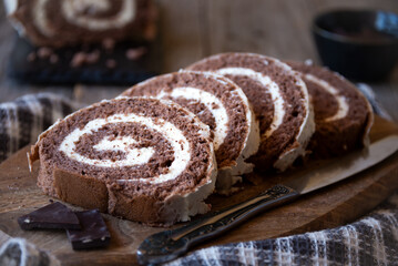 Delicious chocolate roll cake with white cream, homemade baked dessert