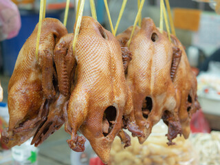 Steamed duck with black soy sauce ready to eat hangers for sale in the market.