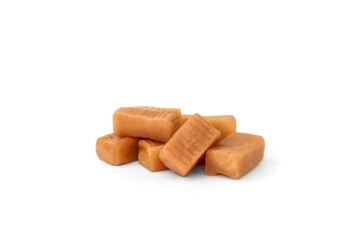 Pile of caramel (toffee) candy isolated on white background.