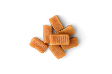 Pile of caramel (toffee) candy isolated on white background.