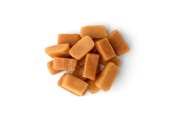 Pile of caramel (toffee) candy isolated on white background.