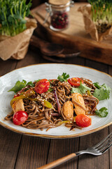 Plate of buckwheat soba noodles with chicken wok