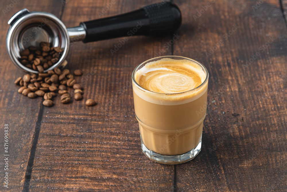 Wall mural cortado coffee with coffee beans next to it. traditional coffee in spain.