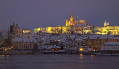 evening Prague in winter - view of snowy Hradcany and Prague Castle