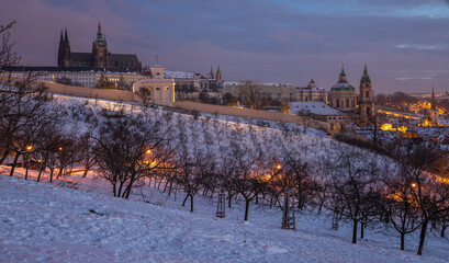 Prague in winter - view of snowy Hradcany and Prague Castle at dawn