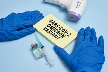 Doctor hand holds a card with text - New covid variant Omicron. Covid-19 new variant - Omicron....