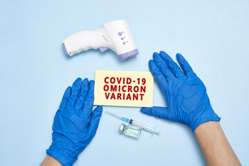 Doctor hand holds a card with text - New covid variant Omicron. Covid-19 new variant - Omicron....