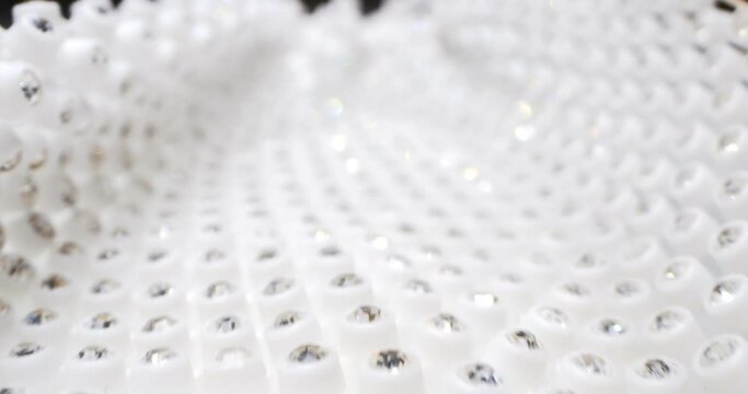 detailed extreme close-up silver rhinestones on white fabric