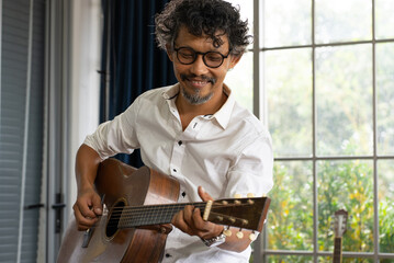 candid portrait of mature musician playing guitar
